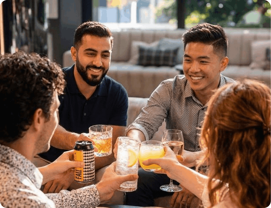 Happy guests toasting drinks at a restaurant table