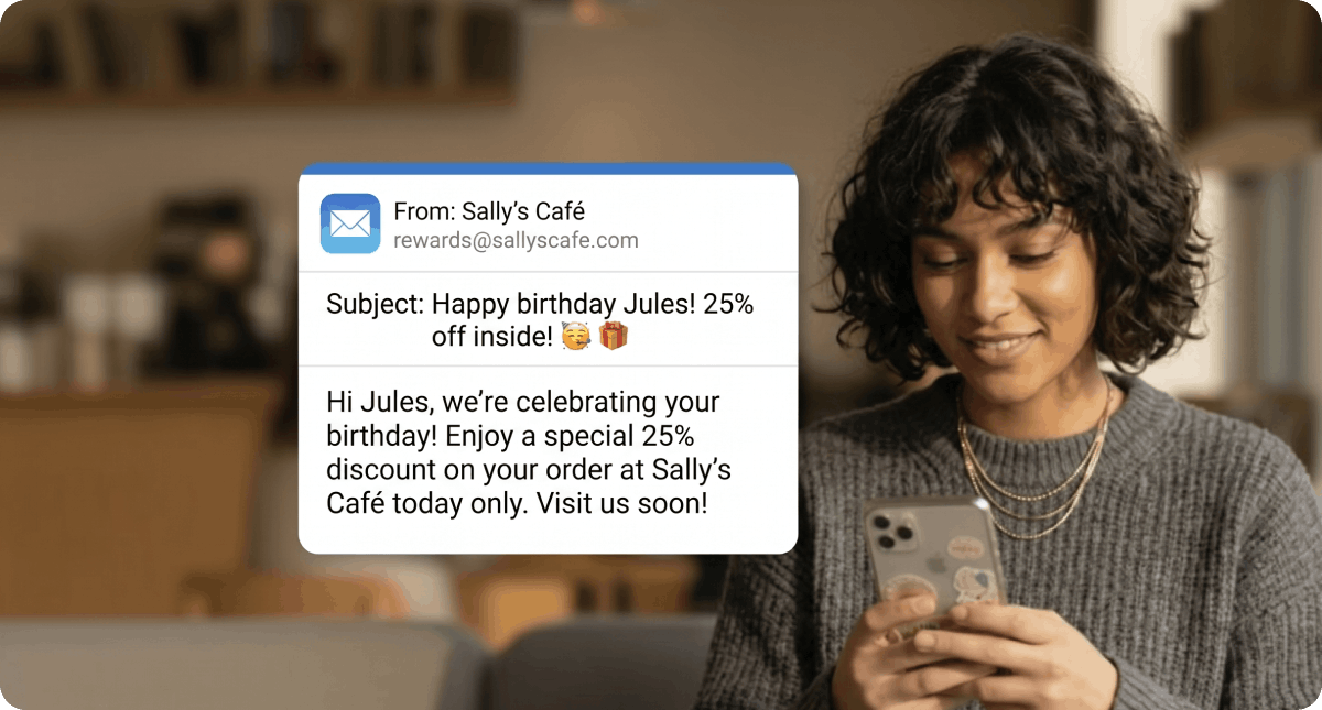 Guest reading a personalized birthday email promotion from a cafe on her smartphone